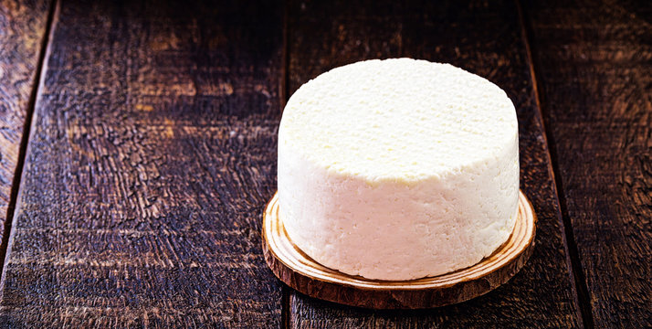 Fresh cheese made in minas gerais, on a rustic table.