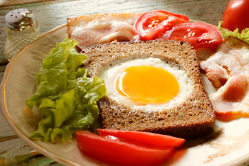 Fried eggs, omelet traditional rustic breakfast, fried eggs, roasted bacon, sausage for breakfast .  Healthy food