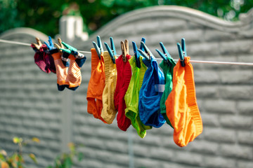 Children's clothes drying on the clothespins. Children's panties and socks hang on clothespins