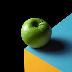 apple on a multi-colored background. Creative concept.