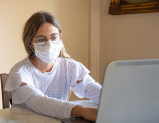 Girl working at home office due to the quarantine of cronavirus