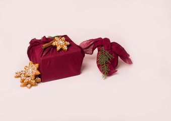 A beautiful gift packed with furoshiki technique, with gingerbread and cinnamon stick
