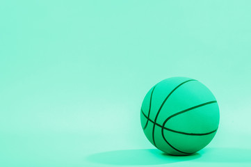 Basketball ball isolated on green background.