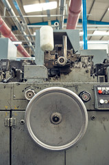 A toilet paper making machine, producing toilet and bathroom paper rolls due to Corona virus panic buying.  Paper and tissue manufacturers factory and engineered machinery.