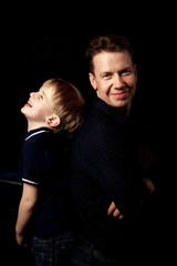 
portrait of father with son on black background