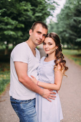 Naklejka premium Loving couple on a city street. Portrait of a guy and a girl of love story. Life style