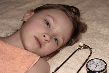 Portrait of a child lying on a bed. Little girl bottom view.