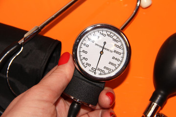Tonometer in a woman's hand with a manicure. A device for measuring pressure.