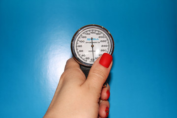 Tonometer in a woman's hand with a manicure. A device for measuring pressure.