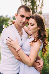 Portrait of a happy couple in love with flowers, hugs, love story, sunny photo
