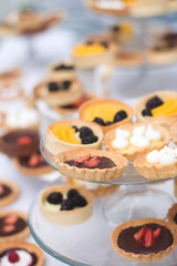 tartaletas y pasteles de frutas en mesa blanca 