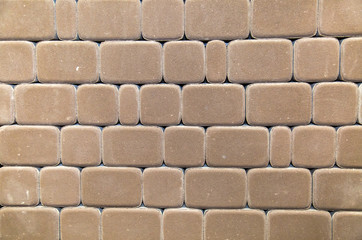 Grey paving tiles in the form of rectangles and squares with rounded corners. Construction,...