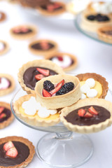 tartaletas y pasteles de frutas en mesa blanca 
