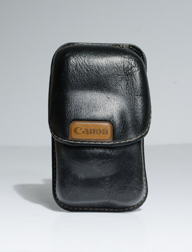 london, england, 05/05/2019 A retro vintage canon film leather camera pouch and case, isolated on a white background. Protective leather bag to protect vintage antique retro film cameras