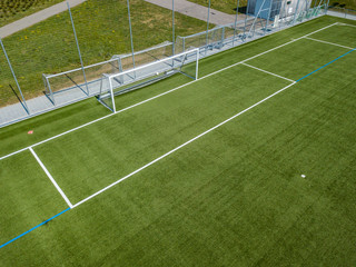 Aerial view of football goal and penalty area. Empty soccer field with white lines.