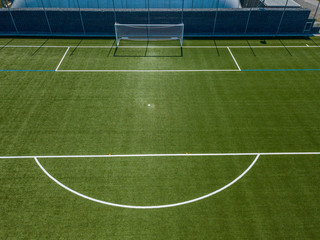 Aerial view of football goal and penalty area. Empty soccer field with white lines.