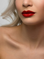 Sexual full lips. Natural gloss of lips and woman's skin. The mouth is closed. Increase in lips, cosmetology. red lipstick. Open mouth and with teeth. blonde hair. face powder on clean skin