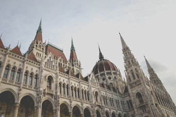 Fototapeta na wymiar Building of the Hungarian Parliament Orszaghaz in Budapest, Hungary. The seat of the National Assembly. House built in neo-gothic style. Sunset light shining on the building. Horizontal photo