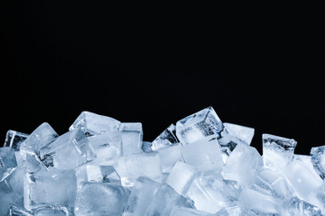 Ice cubes on black background, closeup view
