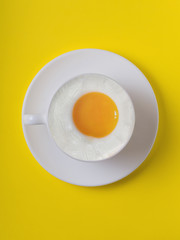 white cup of egg. yellow background. protein in the cup. eggs is healthy breakfast . illustrator egg in the cup. cup of protein egg  