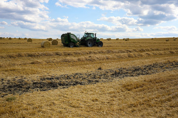 Fototapeta premium Tractor and trailer on the field
