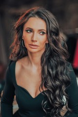 Fototapeta premium portrait of a very beautiful woman with long hair in a black dress