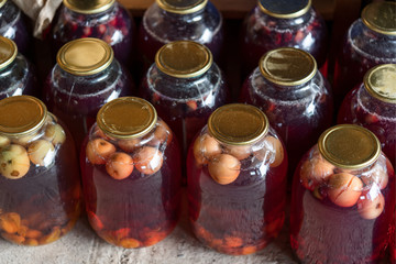 Glass jars with apple compote. Blurred background. View from above.