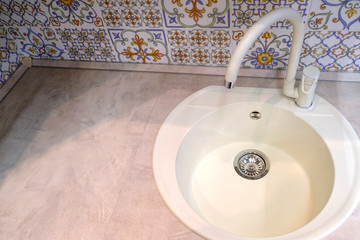 Kitchen sink. Cleanliness and hygiene in conditions of quarantine. Ceramic washbasin. Water mixer.
