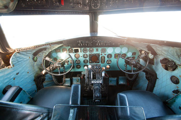 Cockpit of old plane with pilot's seats and control panel