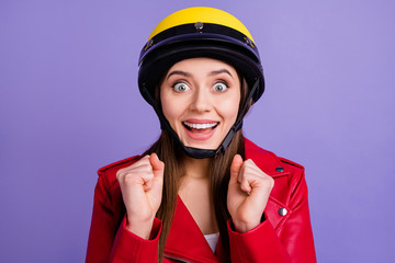 Close up photo of crazy positive cheerful girl raise fists cant wait incredible motorbike extreme journey wear biker outfit isolated over violet color background