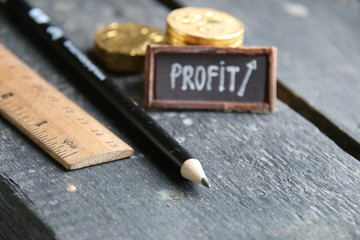 profit concept, stacks of gold coins and a tag with the inscription