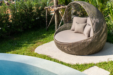 Exterior design of villa, house and home feature round shape sun bed and cushion by swimming pool
