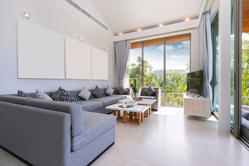 Interior design in villa, house, home, condo and apartment feature sofa, middle tale and television in living room with view