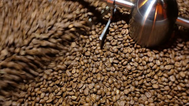 Closeup Selective focus coffee roaster with coffee beans.