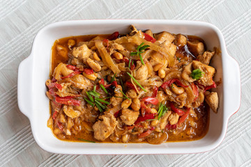 delicious kung pao chicken dish served on a ceramic tray on a tablecloth