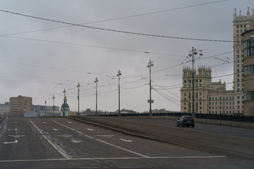 Lonely car. No people at streets in spring time.  Bolshoy Ustinsky Bridge. Concepts - Stay at home, save live. Concepts of social distancing and self-isolation. 