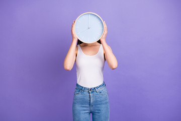 Portrait of charming girl hide her head with round clock watch show deadline time wear good look...
