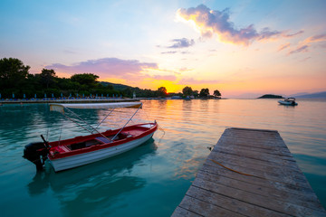 boat on sea, long time exposure during sunset in Albania