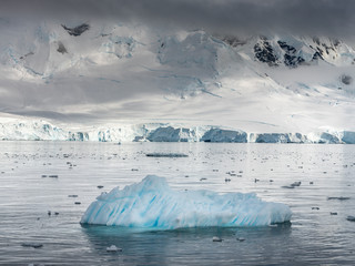 little iceberg on foreground and view to typical antarctic landscape