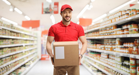 Delivery guy with a box in a supermarket