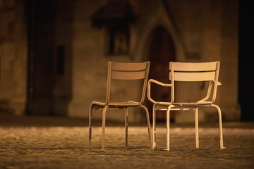 Empty chairs on the Zurich streets in the night