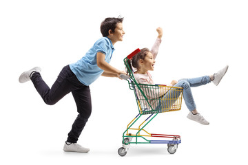 Little boy pushing a little girl inside a shopping cart © Ljupco Smokovski