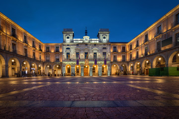 Avila, Spain. View of central market square (Plaza Mercado Chico) with historic building of Town Hall at dusk