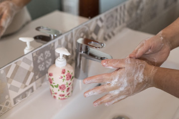 woman washes her hands with soap, disinfects her hands from viruses