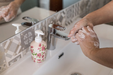 woman washes her hands with soap, disinfects her hands from viruses