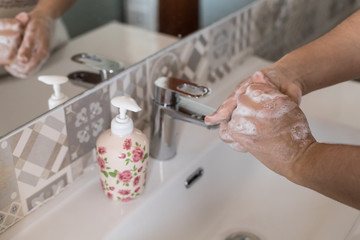 woman washes her hands with soap, disinfects her hands from viruses