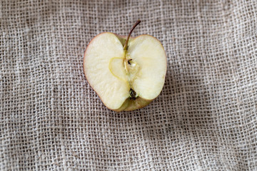 half apple on a jute tablecloth