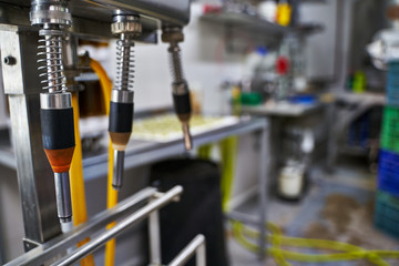 Selected focus of the tools for filling beer bottles in a brewery