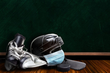 Fototapeta premium Ice Hockey Helmet Wearing Mask With Chalkboard Background and Copy Space