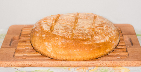 Freshly baked home made bread on board.
